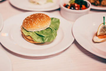hamburger and other dishes on the table in the restaurant