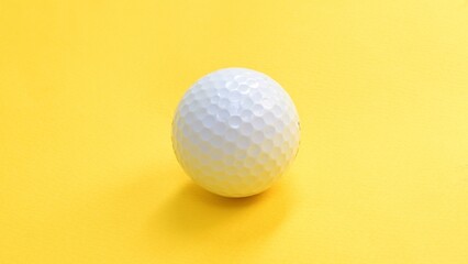 Golf ball sport equipment isolated on yellow background