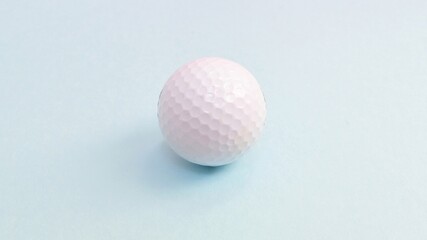 Golf ball, sports equipment isolated on blue background