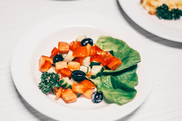 salad with vegetables and olives on the dining table