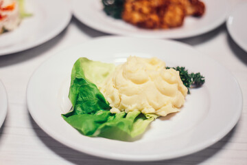 plate with mashed potatoes on the dining table