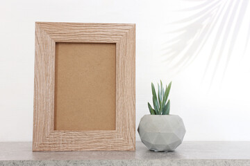 white background and table with empty photo frame for product display