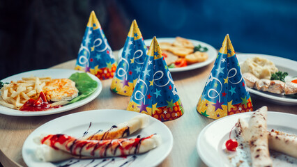 funny hats and delicious dishes on the festive table