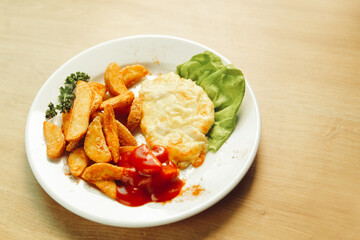 chicken in cheese and garnish on a white plate