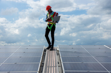 Engineer working setup Solar panel at the roof top. Engineer or worker work on solar panels or...
