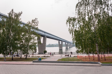 Novosibirsk, Russia, August 2022: Embankment in Novosibirsk and bridges across the Ob River in summer