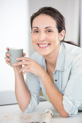 portrait of dreamy brown haired freelance having hot beverage