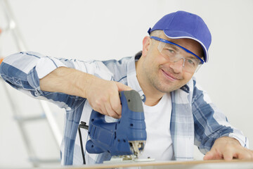 repairman carpenter working cutting wood on circular saw