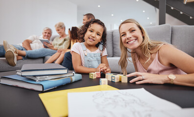 Happy, living room and mother playing with her child while bonding with the family in modern home. Education, happiness and interracial mom and girl kid learning with wood building blocks in house.