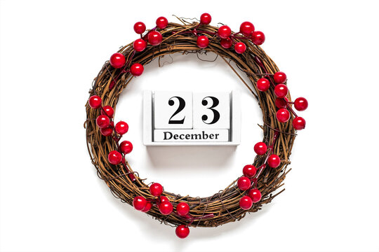 Christmas wreath decorated with red berries, wooden calendar date 25 December isolated on white background Concept of Christmas preparation, atmosphere Wishes card Hand made Christmas wreath Flat lay