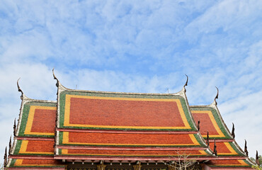 Part of the Roof of a temple in Thailand. Traditional Thai style pattern on the roof of a temple with Blue Sky Background.