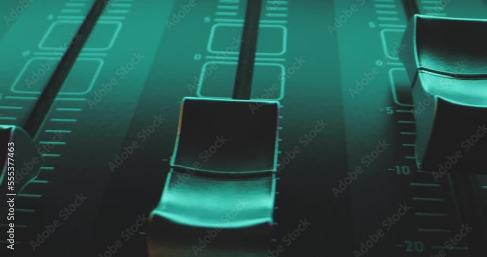 Poster extreme close-up camera pan over individual faders of audio mixer in colorful pulsating light of par