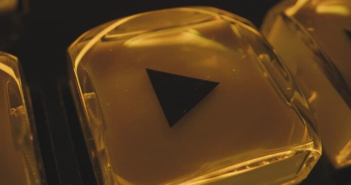 Close-up transparent play and stop button on control panel in pulsating light