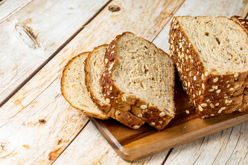 sliced wholemeal bread with cereal over wooden table