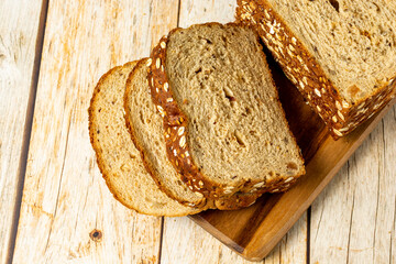 slices of wholegrain bread with cereal on wooden table