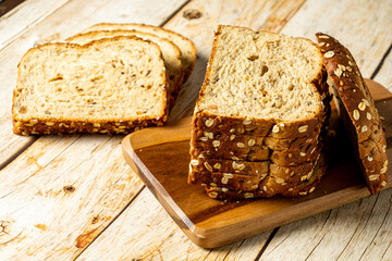 slices of wholegrain bread with cereal on wooden table