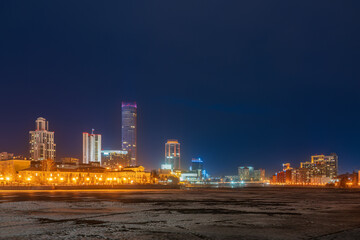Fototapeta na wymiar Yekaterinburg city with Buildings of Regional Government and Parliament, Dramatic Theatre, Iset Tower, Yeltsin Center, panoramic view at Early Spring night