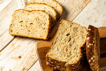 slices of wholegrain bread with cereal on wooden table