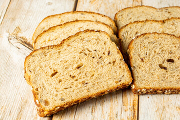 slices of wholegrain bread with cereal on wooden table