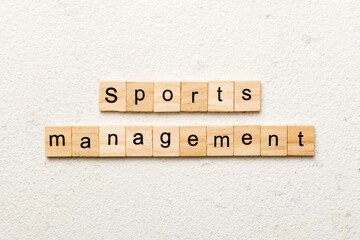 sports management word written on wood block. sports management text on cement table for your desing, concept