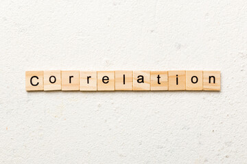 correlation word written on wood block. correlation text on table, concept