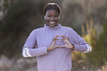 Black woman, fitness and hands in heart gesture, sign or symbol in love for healthy cardio,...