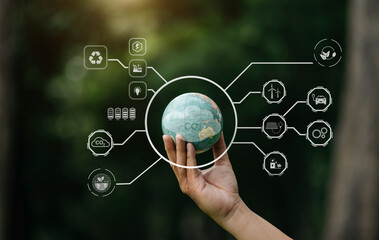 Earth in nature's time in hands with energy resource icon. Earth day. Energy saving concept. in sun light.
