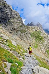 A man hikes the trail to Balcon de Pineta, a popular route in the Spanish Pyrenees