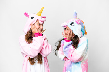 Friends girls with unicorn pajamas over isolated white background