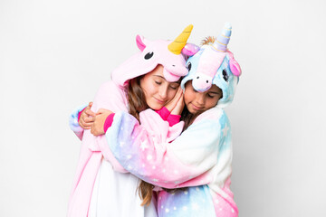 Friends girls with unicorn pajamas over isolated white background