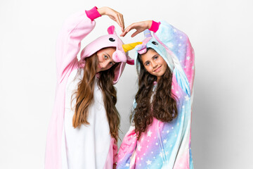 Friends girls with unicorn pajamas over isolated white background
