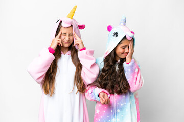 Friends girls with unicorn pajamas over isolated white background unhappy and frustrated with something