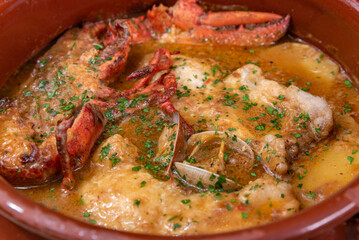 Monkfish and lobster soup with shellfish close-up