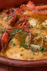 Monkfish and lobster soup with shellfish close-up