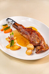 Baked goat shoulder with sauce and vegetables