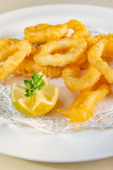 Freshly made Roman calamars with lemon wedge