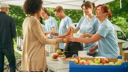 Group of Volunteers Preparing Free Food Rations for Poor People in Need. Charity Workers and...
