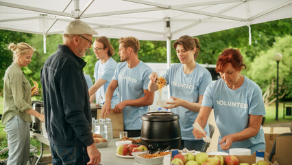 The Concept of Giving: Homeless People Reach Out To Free Volunteer Meals from Multiethnic Team of...