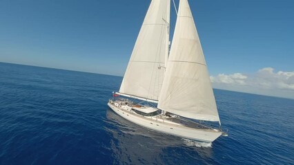 FPV drone orbit around sailing Oyster 82 sailing yacht with sails hoisted