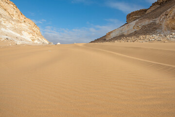 Barren desert landscape in hot climate with sand dunes