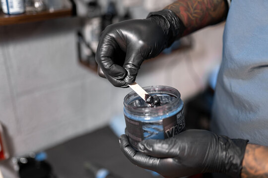 A Tattoo Artist Is Picking Up Some Black Skin Vaseline Before Work