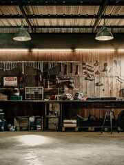 Workshop scene. Old tools hanging on wall in workshop, Tool shelf against a table and wall, vintage garage style