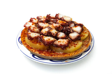 Appetizing and healthy plate of octopus with potato baked in olive oil, traditional food in Galicia, north of Spain.