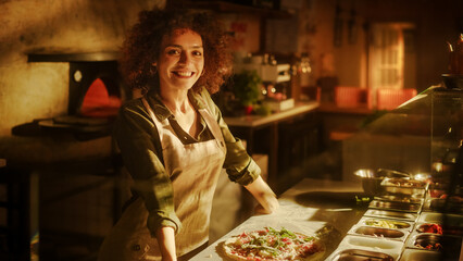 In Restaurant Portrait of Professional Chef Finishing Preparing Pizza, looking at Camera with a Smile. Traditional Family Italian, Recipe. Authentic Sunny Pizzeria, Cooking Delicious Organic Food