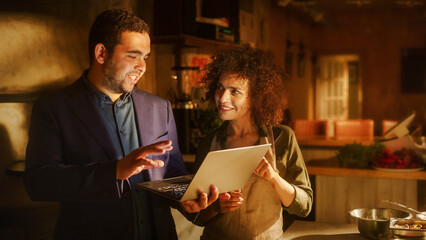 Restaurant Small Business Owners: Happy Male and Female Business Partners Use Laptop Computer, Discuss Growth Strategy. Two Entrepreneurs Working on Optimization of Online e-Business Orders in Shop