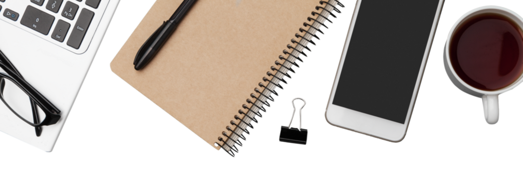 Office workspace with notebook, pen, coffee, clips and accessories.