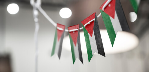 A garland of Jordan national flags on an abstract blurred background