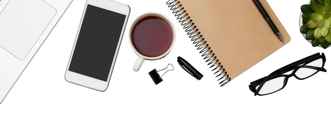 Office workspace with notebook, pen, coffee, clips and accessories.