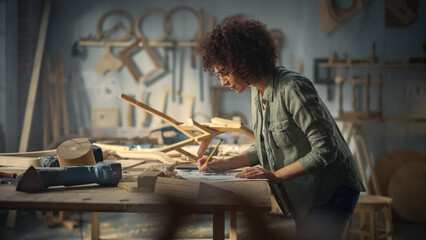 Portrait of a Young Beautiful Carpenter Checking a Blueprint and Starting to Assemble a Wooden...