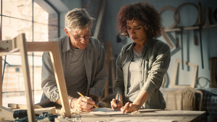 Small Business Owners of a Furniture Workshop Using Laptop Computer and Discussing the Design of a...